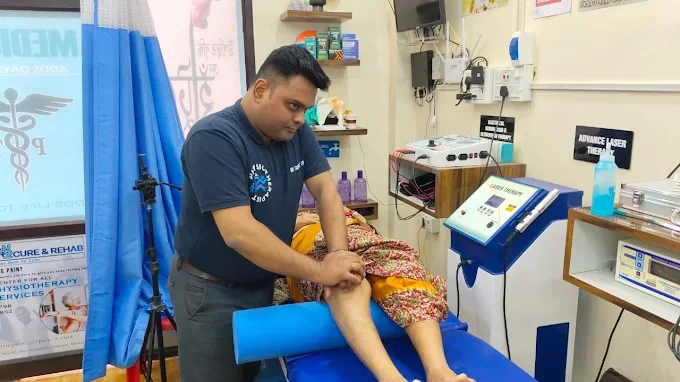 Laser therapy being applied to a patient's knee at the clinic
