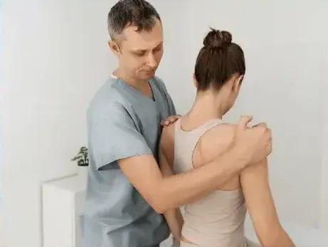 Manual therapy being applied to a patient's back